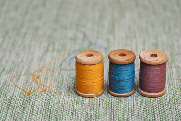 Three vintage wooden spools with old threads from grandma's box. Materials for creativity and...