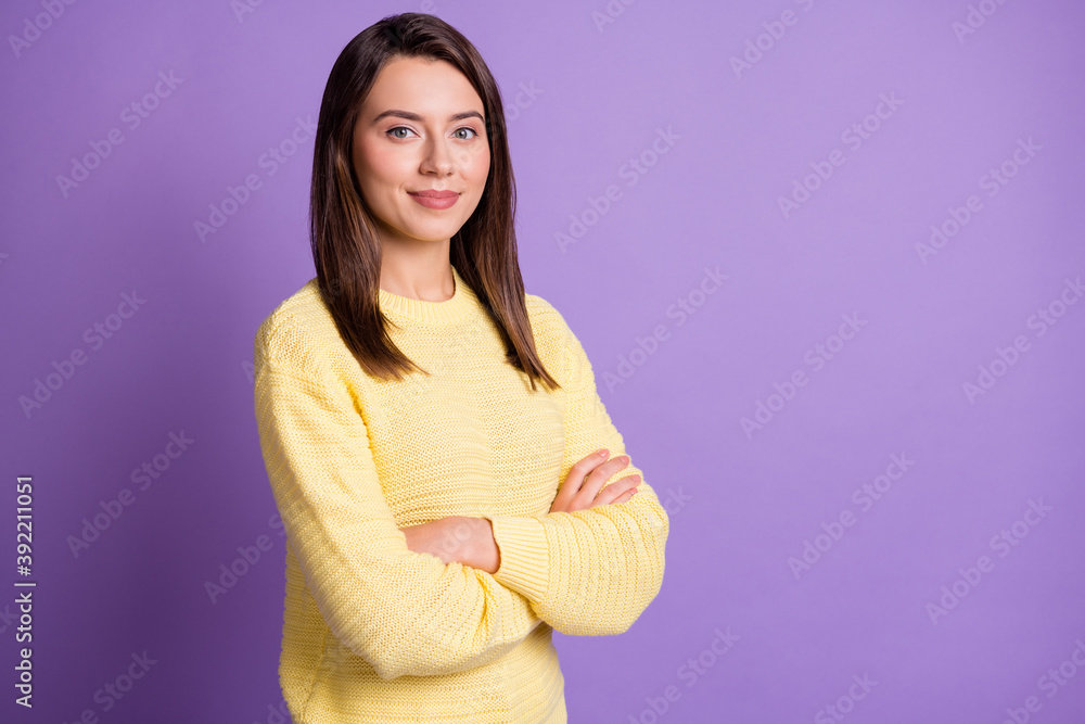 Wall mural photo portrait of serious woman with crossed arms isolated on vivid violet colored background