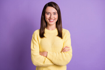 Photo portrait of young happy pretty girl smiling with crossed hands wearing yellow clothes isolated on vibrant violet background