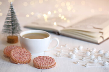 Book, tree, cookies, cup with cocoa and marshmallows.