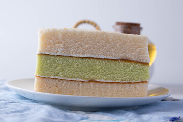 Soft three layers vanilla cake in a white plate