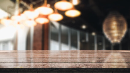 Empty wood table with blur vintage restaurant background.