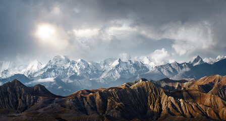 Panoramic view of the scenic landscape of snowy mountains and dramatic clouds - 392214649