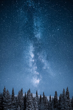 Epic Milky Way Above Snowy Trees And Hills