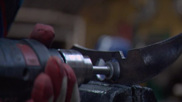 The master processes the part clamped in a vice with a dril