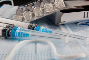 disposable syringes and ampoules with medicine.
