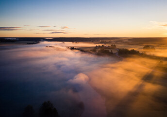 Fototapeta na wymiar Aerial view rural landscape with fog and golden sunrise