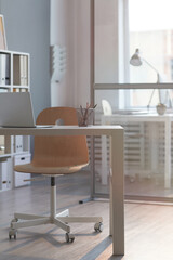 Image of modern workplace with laptop on it at empty office