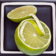 slice of lime placed on half a lemon prepared for a drink