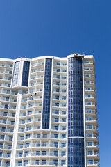 Constructing skyscraper over blue sky, modern architecture.