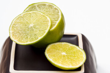 slice of lime placed on half a lemon prepared for a drink