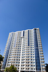 Fototapeta na wymiar Constructing skyscraper over blue sky, modern architecture.