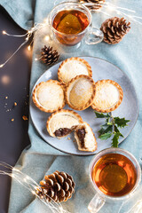 mince pies on a plate shot from above. A mince pie is a traditional Christmas sweet pie, filled with a mixture of dried fruits and spices.