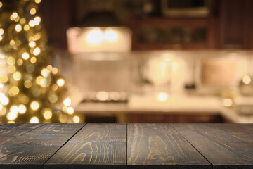 Wooden countertop and blurred kitchen with Christmas tree. Background for display or montage your...