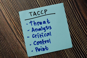 TACCP - Threat Analysis Critical Control Point write on sticky note isolated on Wooden Table.
