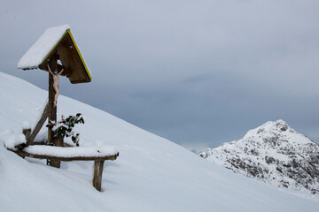 A Crucifix.
Crucifix, little catholic religious sign in snowy mountain.