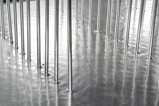 Galvanized parts. Galvanized industrial parts on a construction site. Galvanizing factory process. Galvanizing metal parts in galvanic workshop