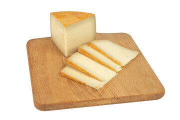 Isolated Heidi goat cheese on a wooden Board with red pepper and walnuts with clipping path on white background