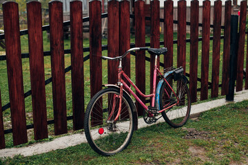 Fototapeta na wymiar bike near the fence near the house