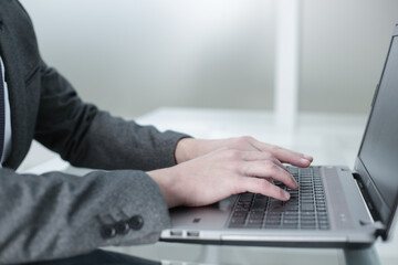 The manager works at the computer in the office