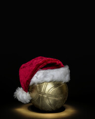 Golden basketball ball with Santa hat