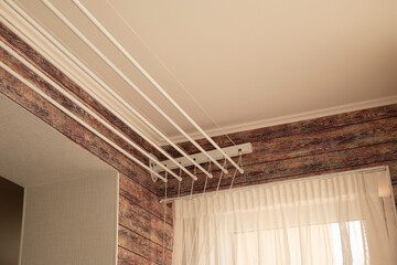 A ceiling linen drayer hanger in the interior of the room