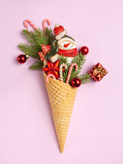 Snowman, Christmas tree twigs and lollipop in a waffle cone. Christmas card. An original sweet...