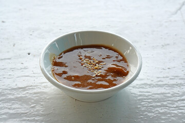 pork chops steak sauce in white cup isolated on white table background         