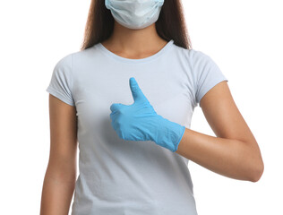 Woman in protective face mask and medical gloves showing thumb up gesture on white background, closeup