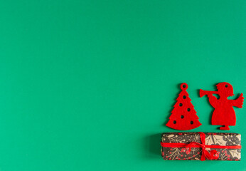  children's Christmas, New Year card - red felt toys and gifts on a green background. Flat lay, copy space, top view