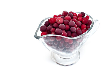 frozen cranberries in a cup on a white background
