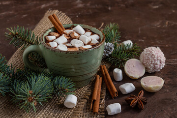 atmospheric Christmas composition, a cup of cocoa with marshmallows, gingerbread cookies, sweets, cinnamon, copy space..