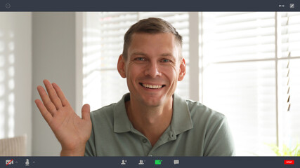 Man communicating with coworkers from home using video chat, view through camera