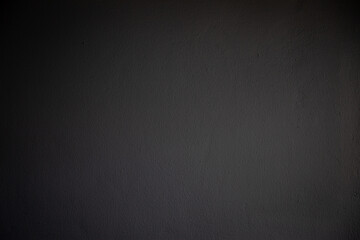 The black wall color and has an uneven surface.