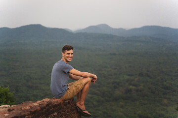 Fototapeta na wymiar young adult observe panorama from lion rock in Sri Lanka