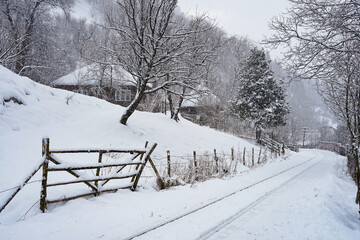 Naklejka premium Winter landscape in Romania, railroad covered with snow