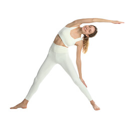 Young woman in sportswear practicing yoga on white background