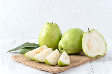 Delicious guava fruit set on white wooden table background with copy space.