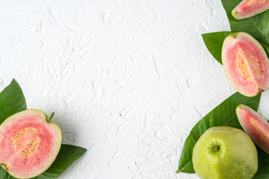 Top view of beautiful red guava with fresh green leaves.