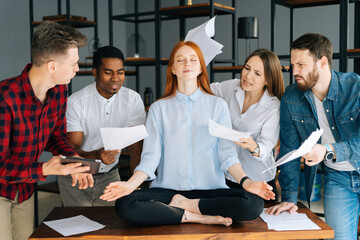 Portrait of calm young business woman meditate at business meeting avoiding pressure annoying angry...