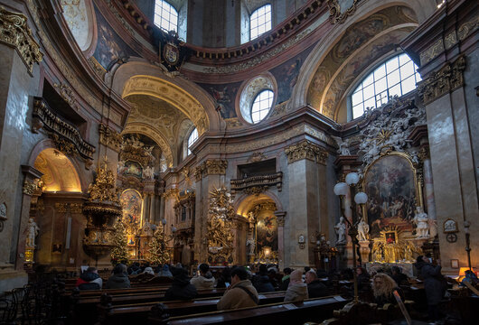 Vienna, Austria - January 28, 2020: Interior view of famous cupola of baroque Roman Catholic parish St. Peter's Church (Peterskirche) on Petersplatz. Details of the dome's frescoes.