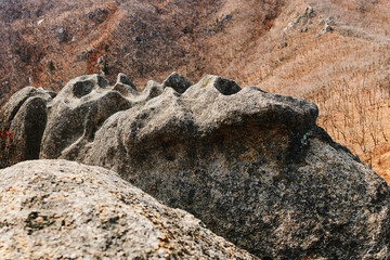 Ancient stone altar in Primorsky Krai, Russia. Wavy stone surface high in the mountains. 