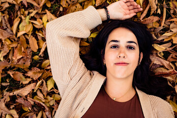 woman lying on tree leaves