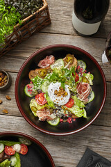 salad with fresh vegetables on a wooden restaurant table