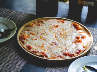 Large pizza and 2 food plates