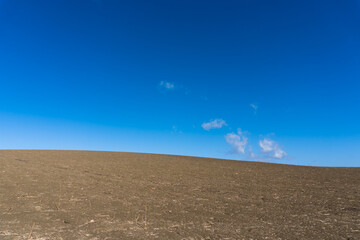 Fototapeta na wymiar Contrasting Blue Sky and Dry Ground