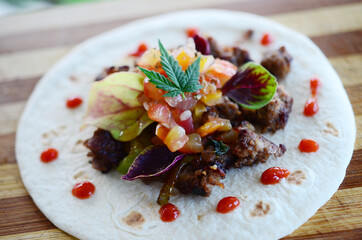 Cooking with cannabis, beautiful and fresh street tacos. Cooking with hemp, beef tacos with fresh salsa and amaranth. Marijuana cooking with cannabutter.