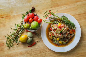 Thai spicy lotus stem salad with Vietnamese pork sausage. Northeast Thai cuisine. Thai street food style