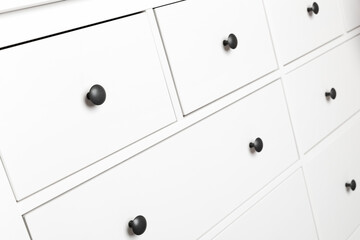 White wooden chest of drawers fragment, close up