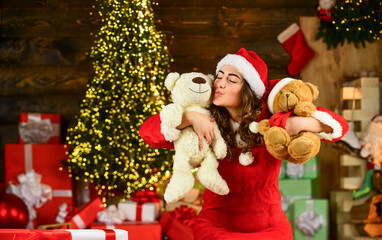 new year tips and ideas. happy girl at xmas party. christmas shopping sales. happy santa woman bear toy present. at the toy shop. decorate your holiday. christmas day is celebrated